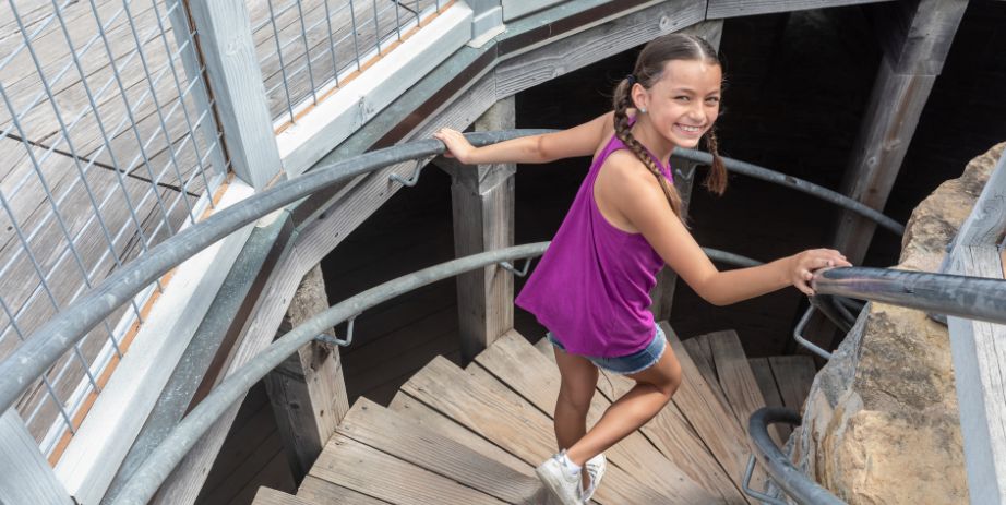 Young girl walking down stairs of the round tower